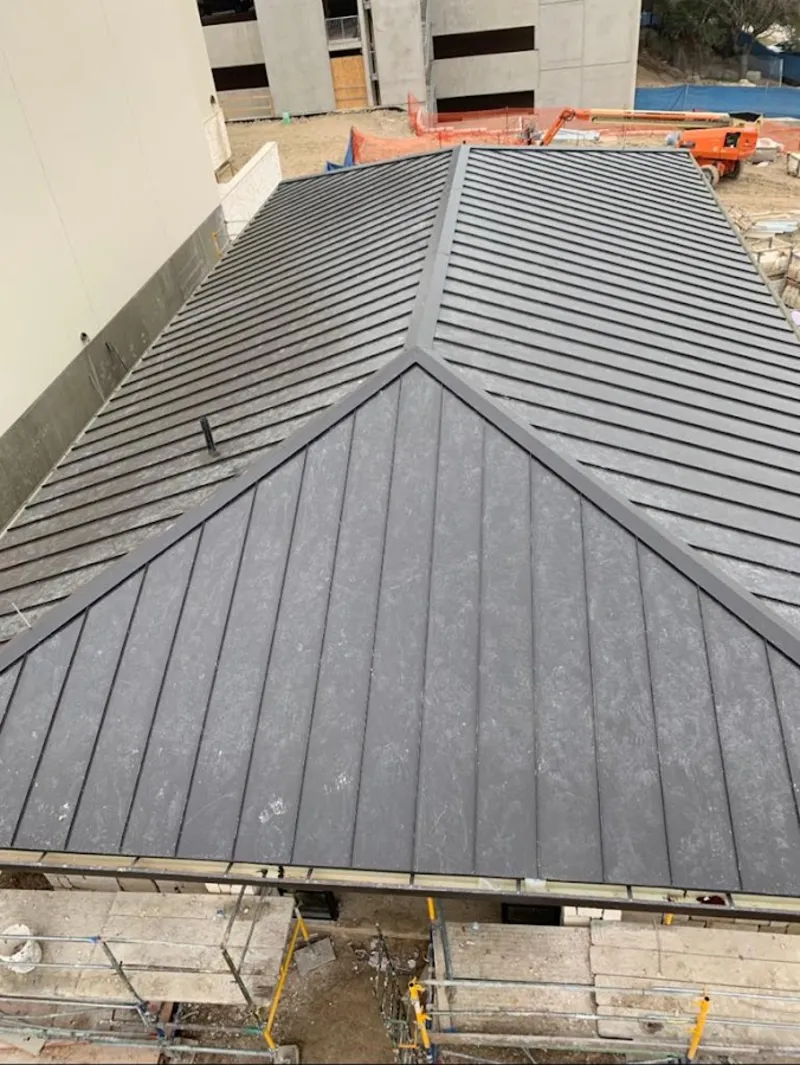 Commercial metal roof construction with crane equipment in El Sobrante